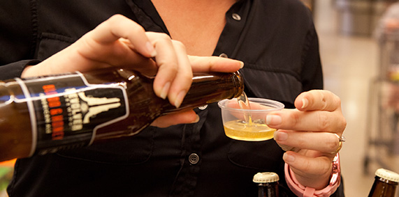 Pourtastic PMB Brand Promoter pouring beer sample at promotional marketing sampling event